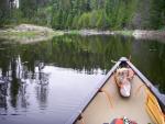 Paddling a second small pond between debris-choked streams along bushwhack route.