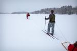 The weather turns to snow on Upper Pauness Lake. Matt, Mallory and Mark look on.