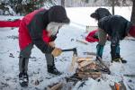 Stocking the wood pile in advance of a cold night ahead.